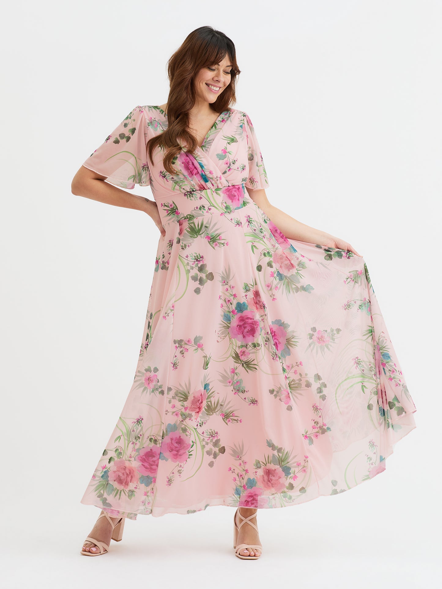 Model wearing pink flower print petite maxi dress with flowing sleeves