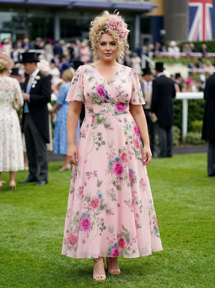 Woman in a floral dress at a formal event with a Union Jack flag in the background